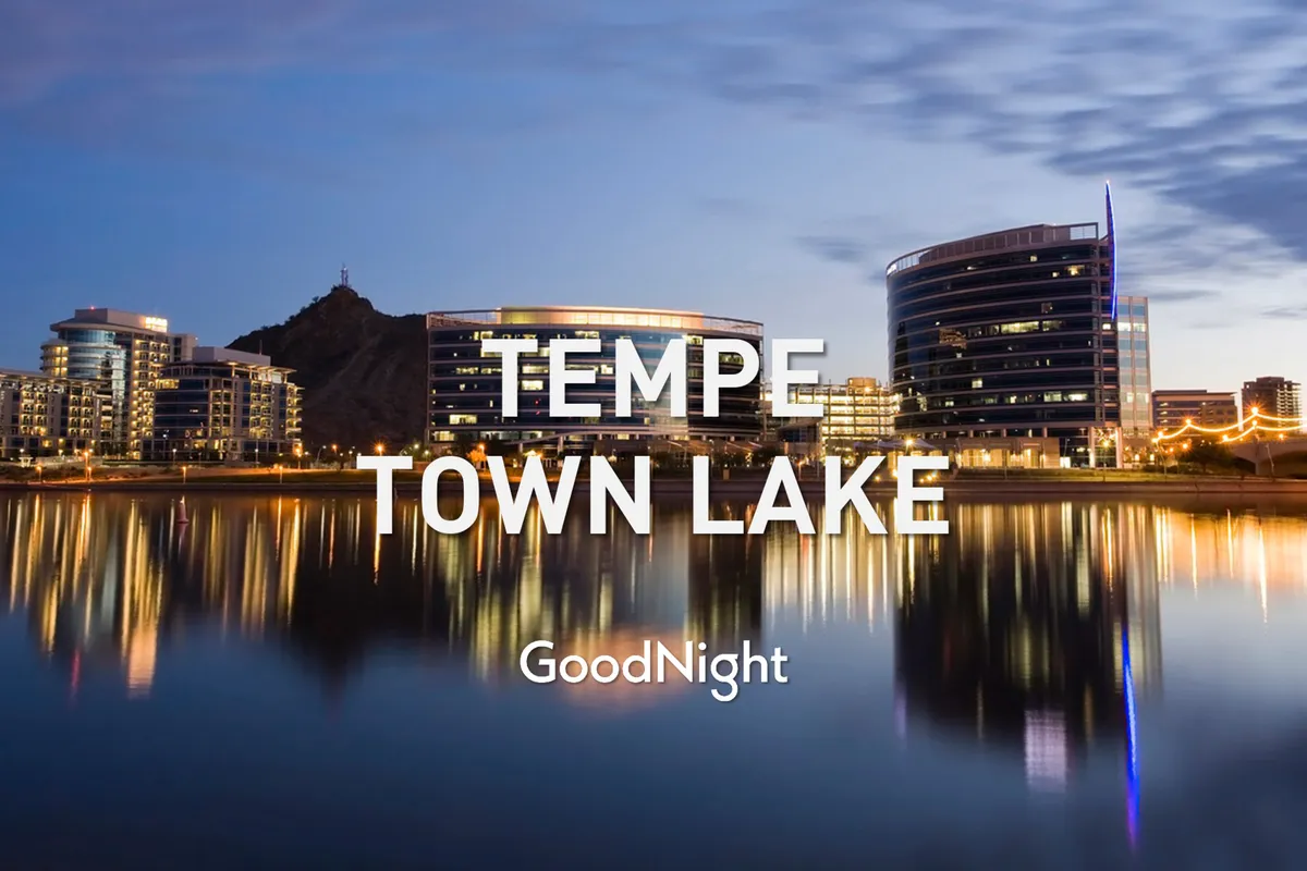 A tranquil evening shot of Tempe Town Lake with modern buildings reflected on the water. The calm ambiance and inviting cityscape emphasize both the relaxing atmosphere and the urban convenience nearby.